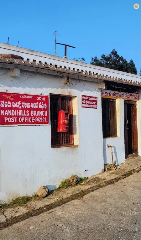 Tiny historic post office at the Nandi Hills summit, reflecting old-world charm amid misty hill surroundings near Bengaluru