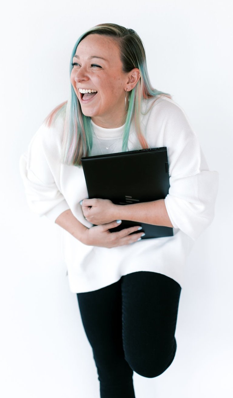tabitha with butterfly effect consulting laughing with her laptop