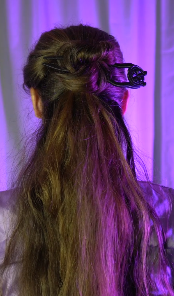 a woman with long hair and a hair comb