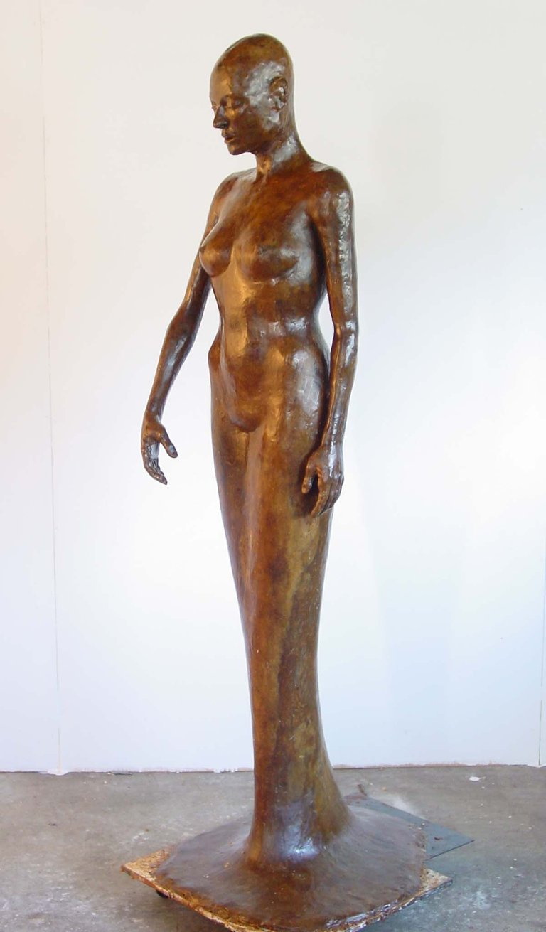 a wax model of a woman standing in a dress