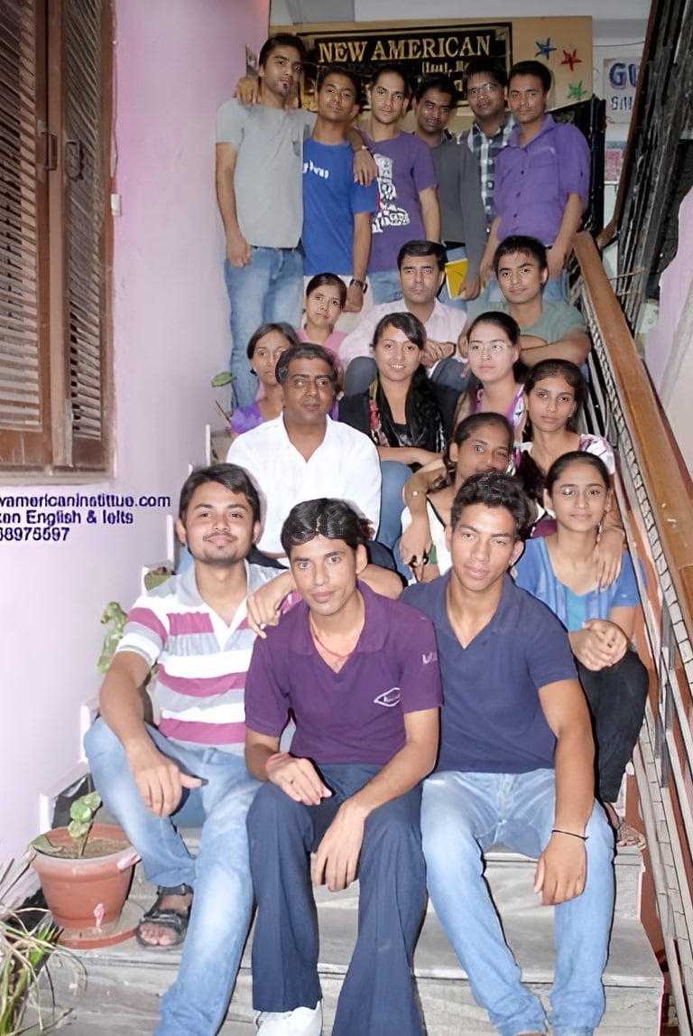 a group of people sitting on stairs with a man in a purple shirt