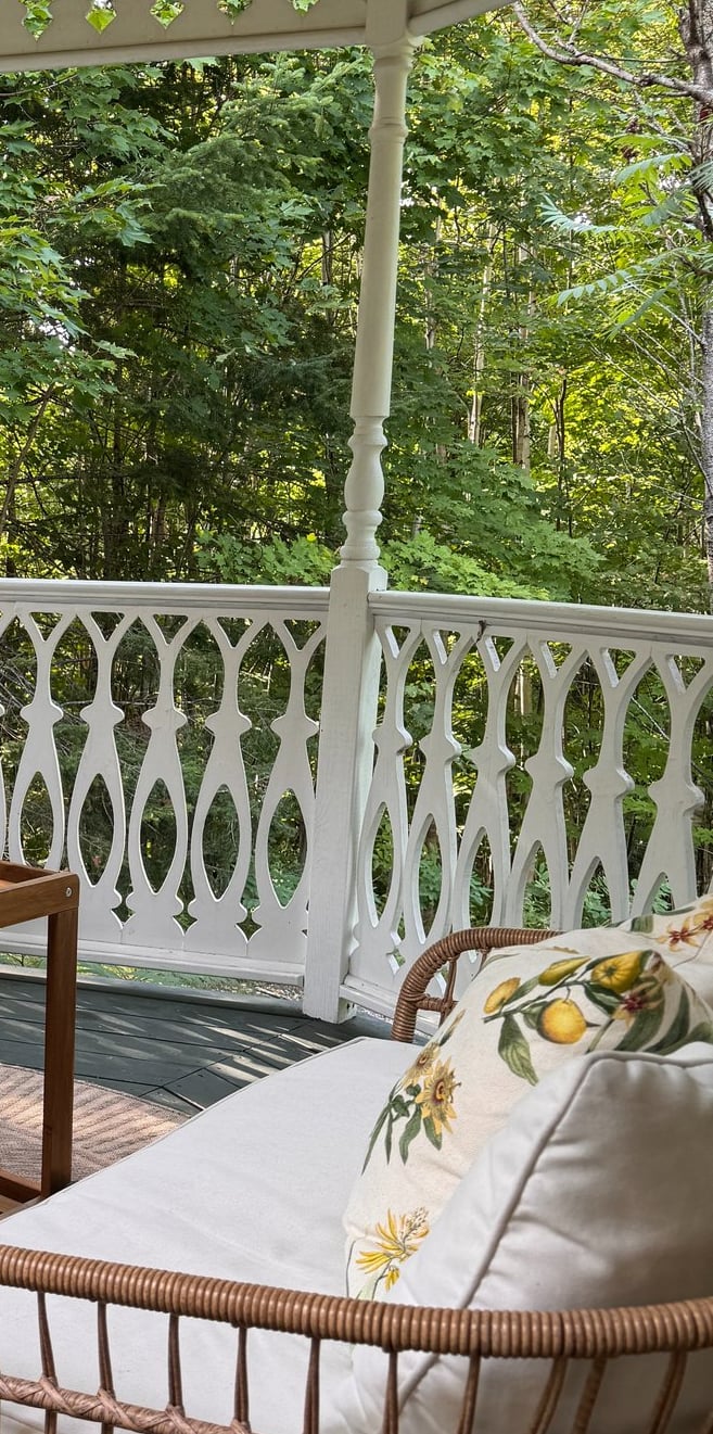 a porch with wicker furniture and wicker furniture