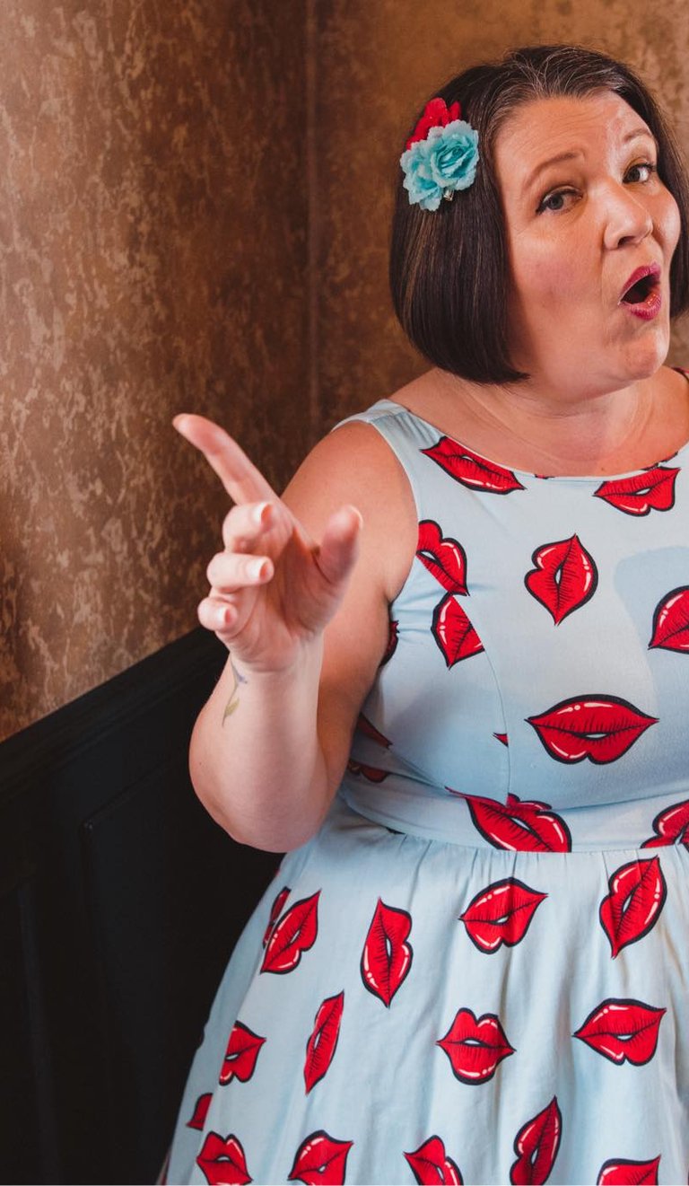 a woman in a dress with lipstick lips on her lips
