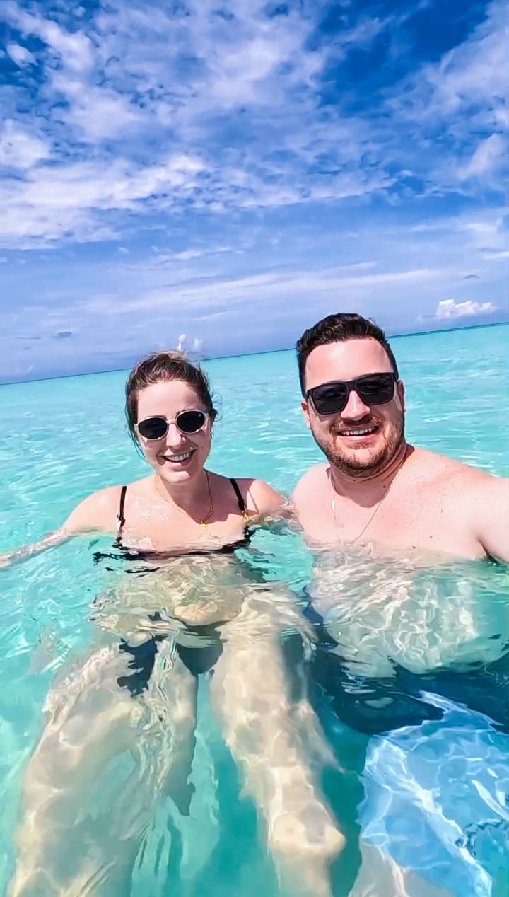 a man and woman in bikinis in the ocean piscina natural on saona island
