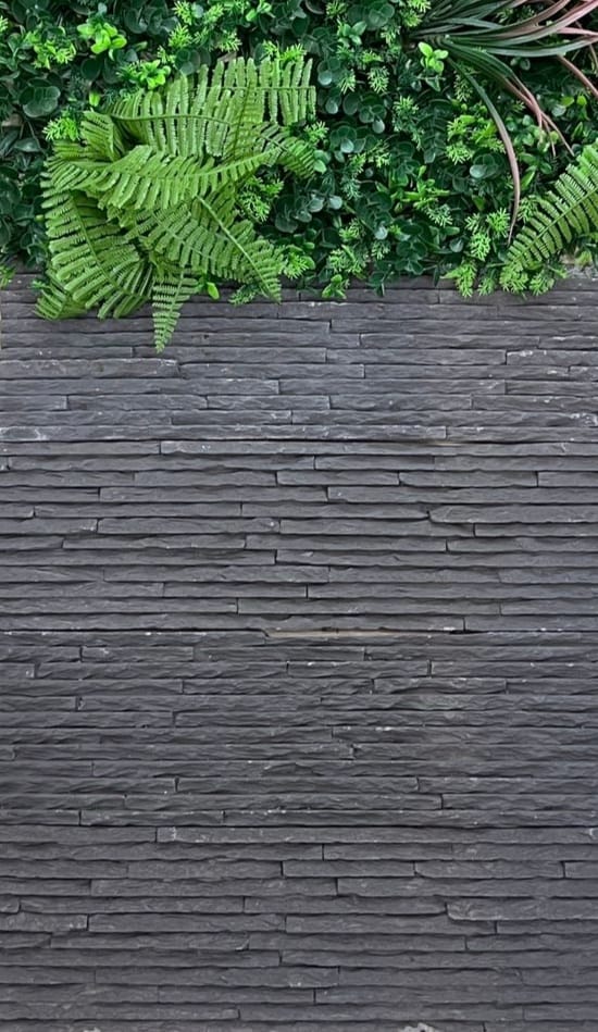 a man in a suit and tie standing on a wooden deck