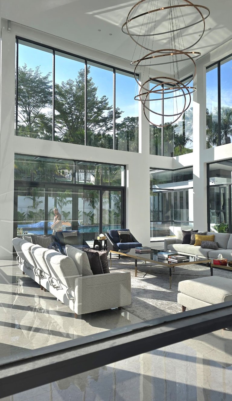 Spacious high-ceiling living room in a custom-built luxury bungalow, featuring premium interior fini