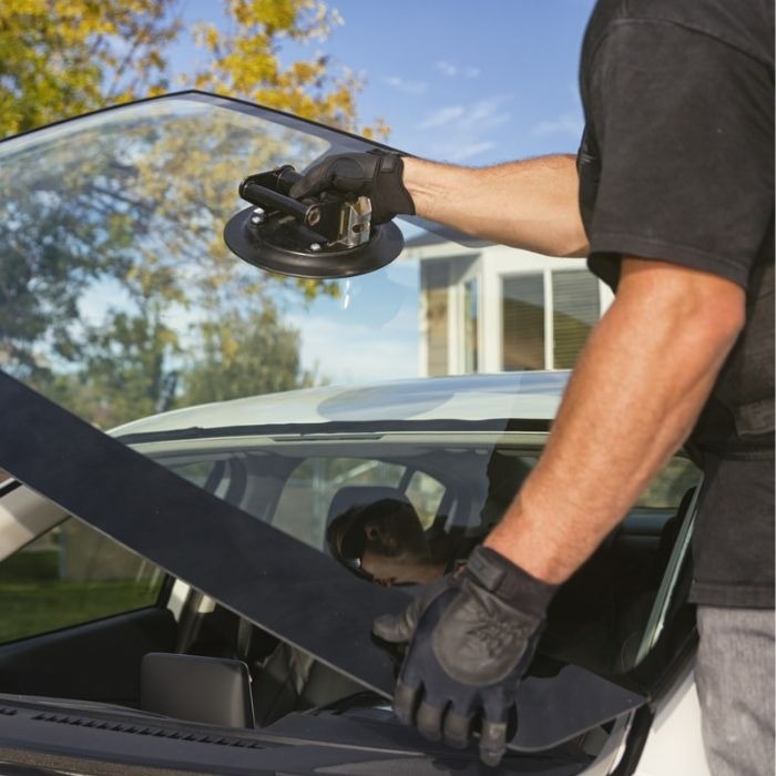 a man in a black shirt is holding a WINDSHEILD
