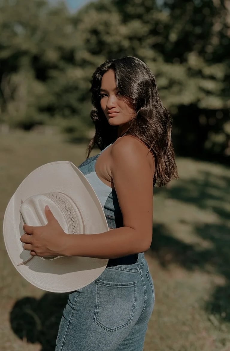 Amelia posing in a jeans top and jeans 