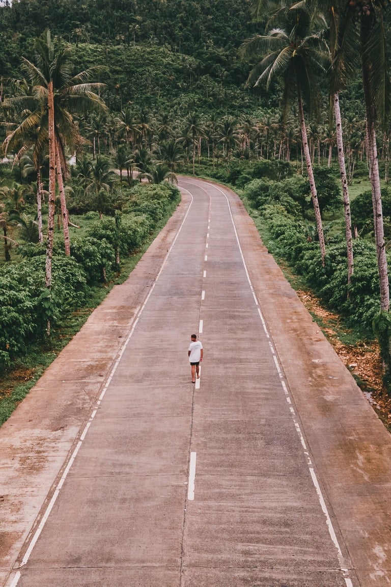 a person riding a bike down a road