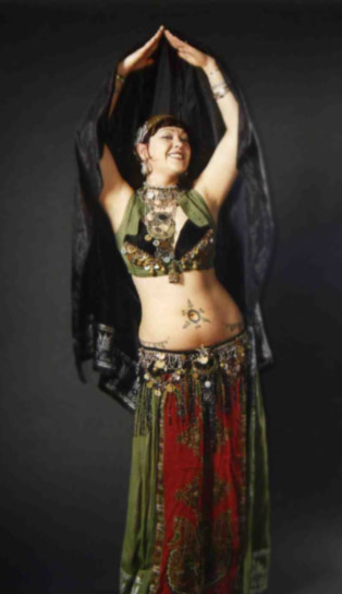 Vintage Bellydancer Shahravar wearing traditional coin costume with red and green costume