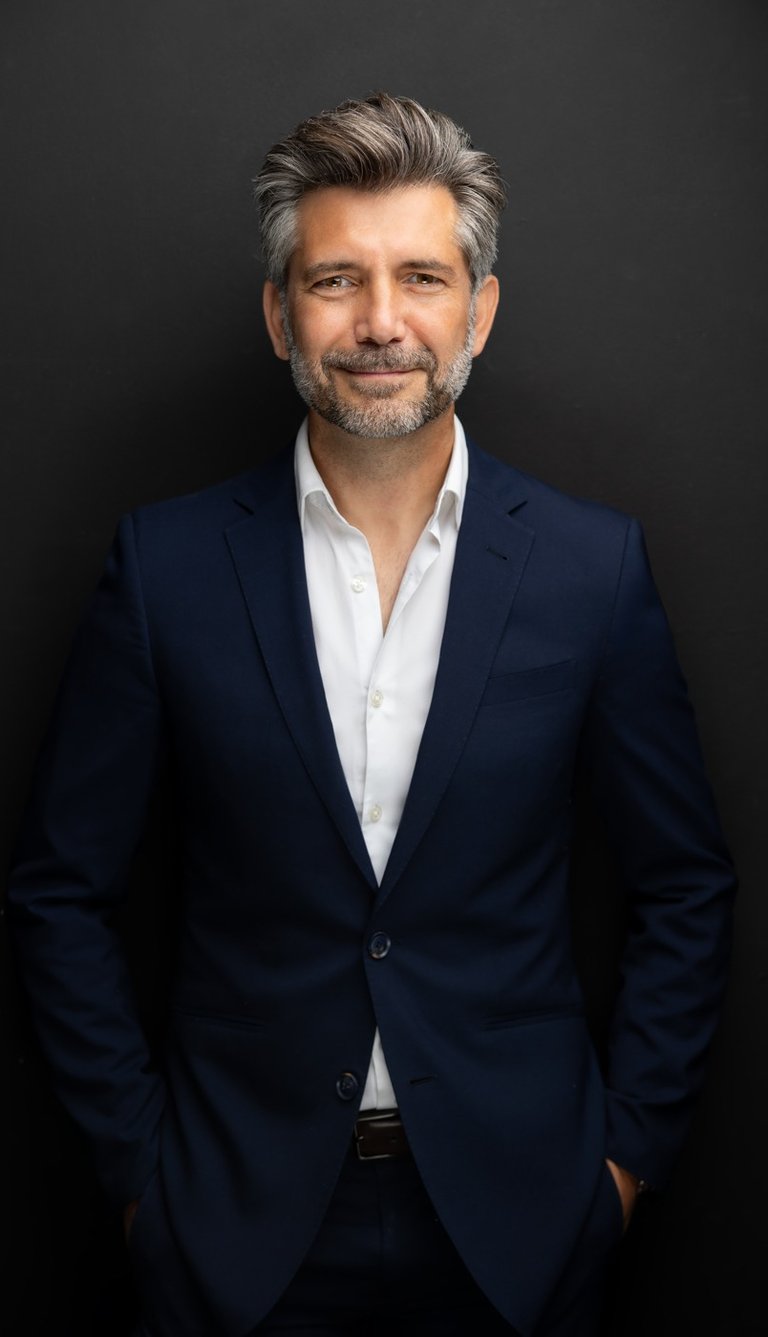 Akin Karaca in a suit and white shirt