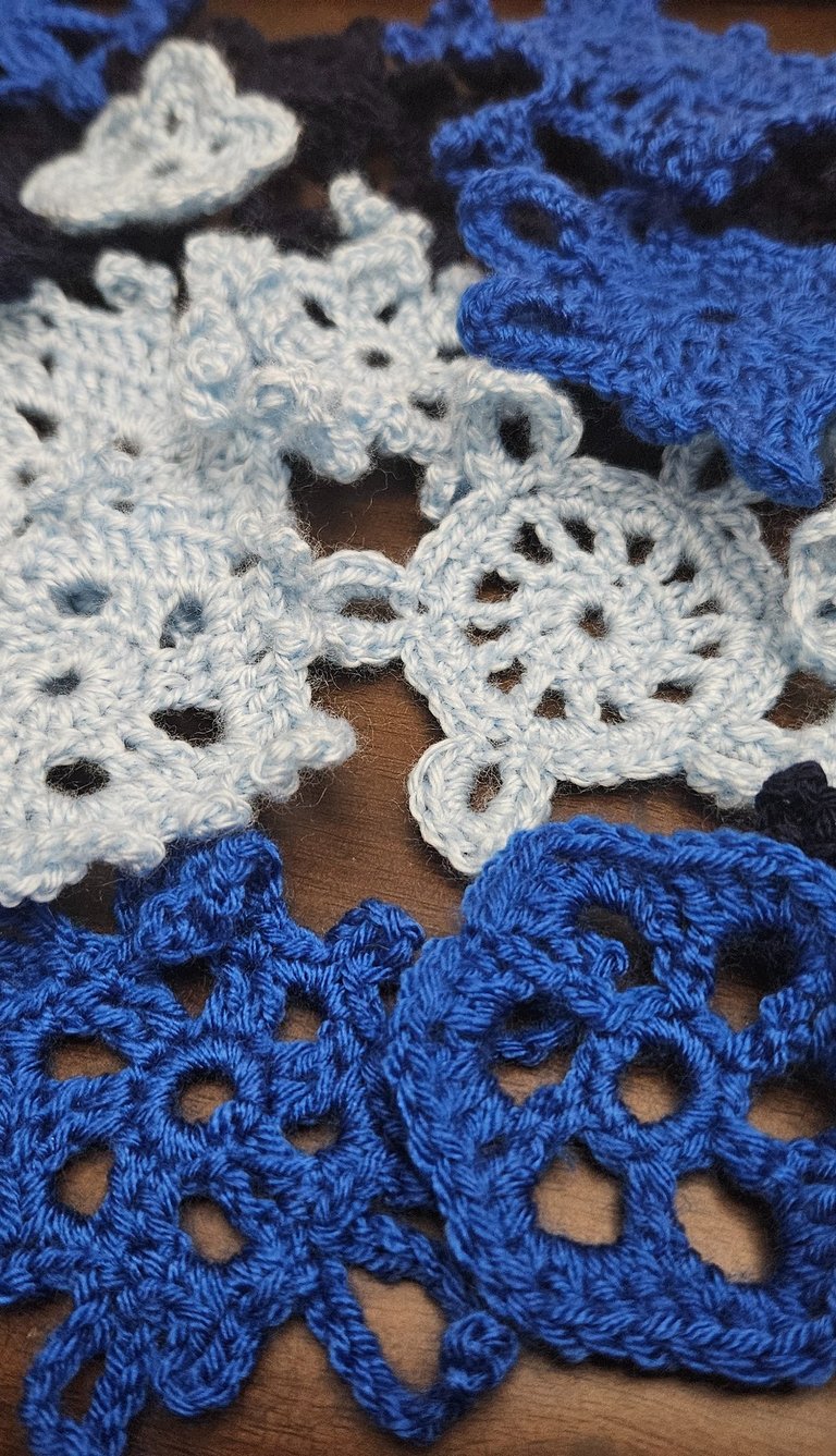 crochet snowflakes on a wooden table