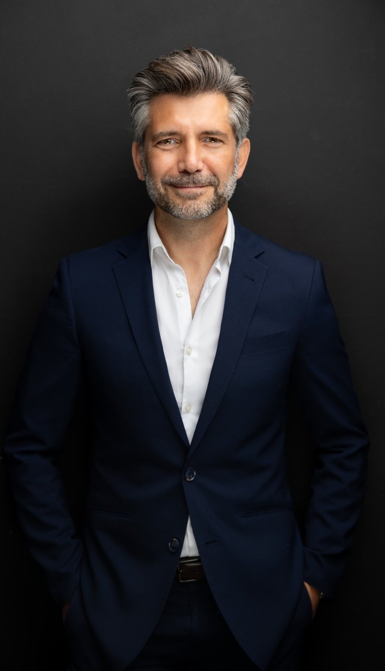 a man in a suit and white shirt