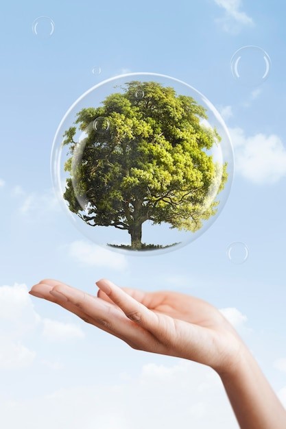 a person holding a bubble bubble bubble in front of a blue sky