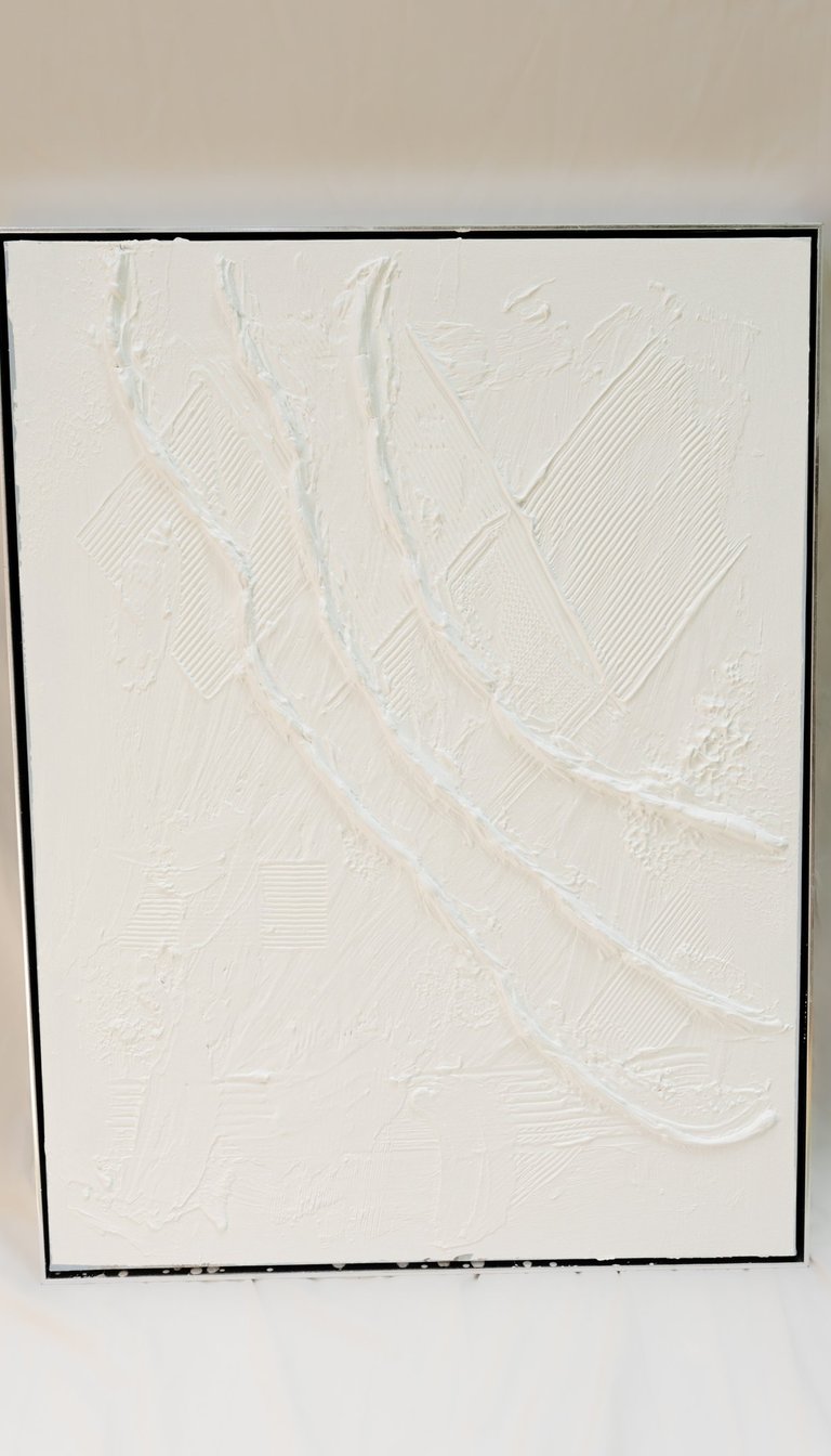 Textured wall sculpture with layered plaster and gentle vertical grooves, contemporary neutral decor
