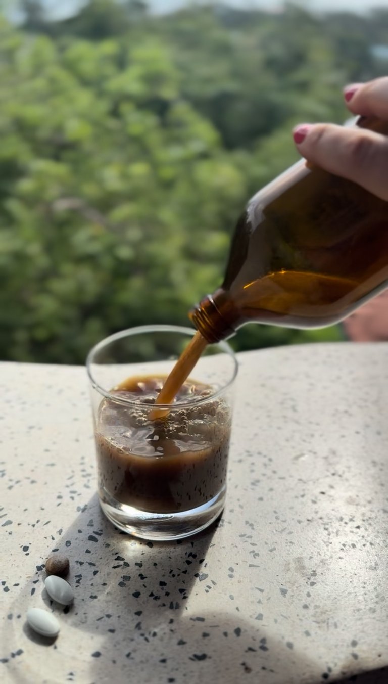 Ayurvedic medicine tonic being poured in a glass