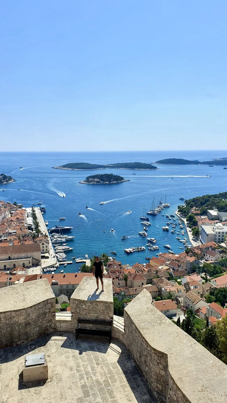 Man at Fortica Fortress in Hvar overlooking Hvar town and Pakleni Islands during private boat tour from Split.