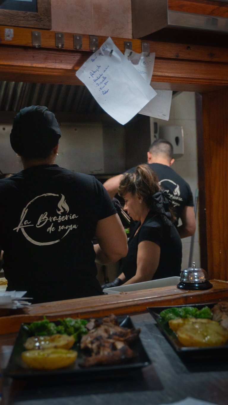 a man and woman in a restaurant kitchen