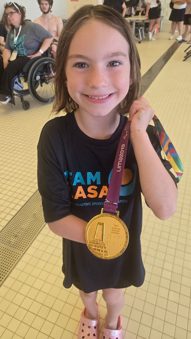 young girl holding a medal