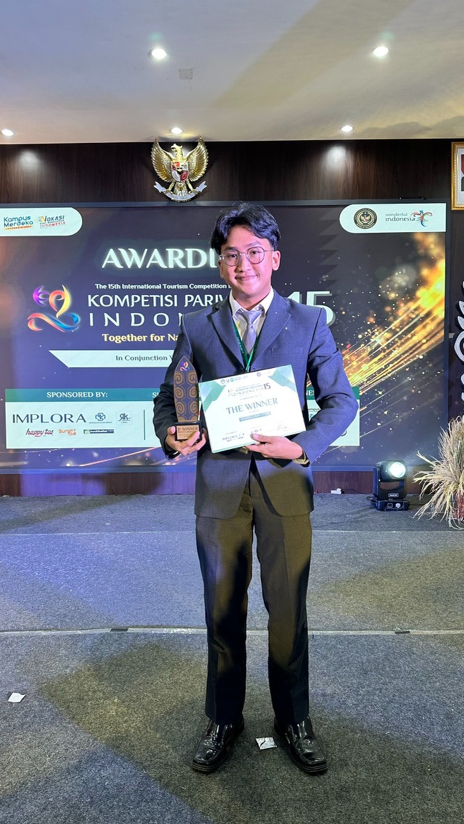 a man in a suit and tie holding a plaque