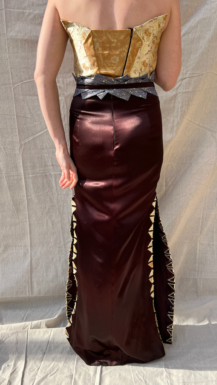 The full back of a gold brocade and brown satin evening gown