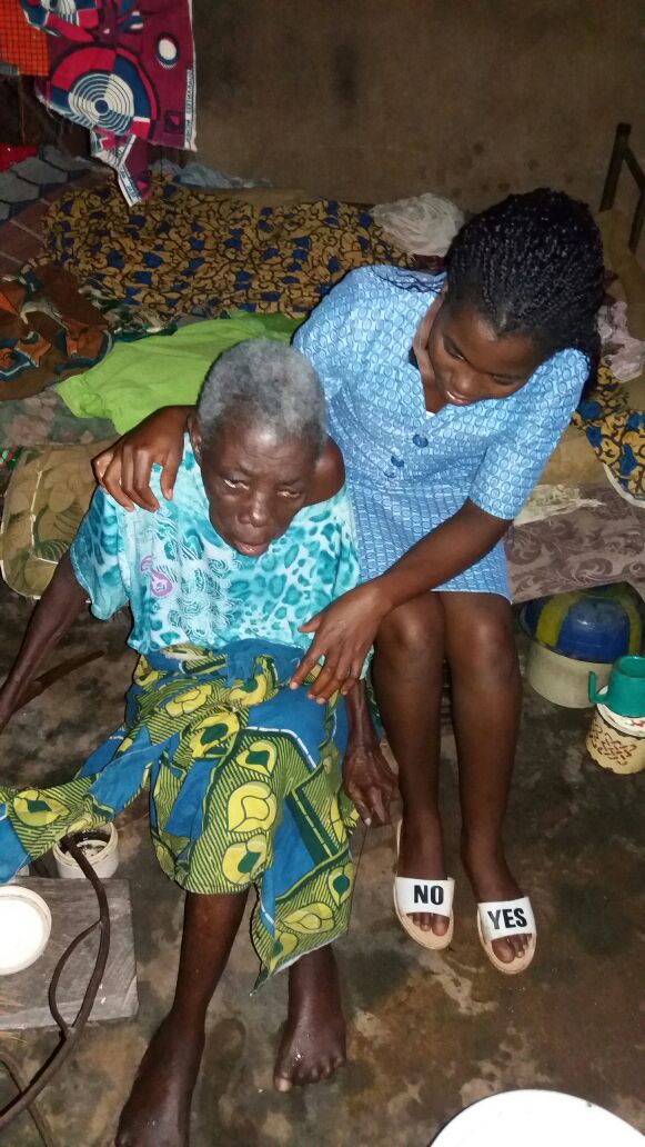 Missionary sister caring for an elderly woman with compassion and support