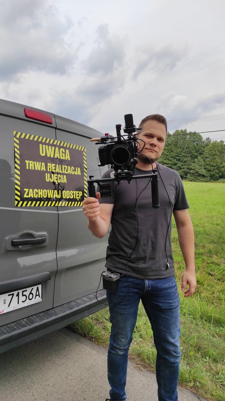 a man holding a camera and a camera