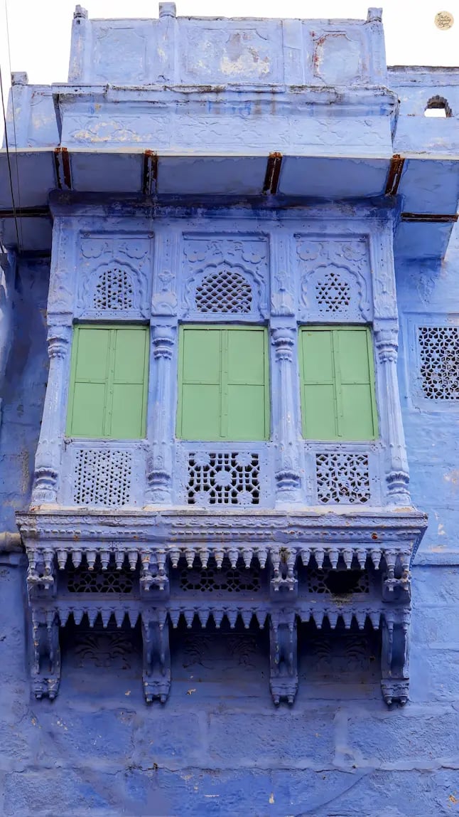 Traditional blue-painted jharokha in the old city of Jodhpur, showcasing Rajasthani architecture and heritage.