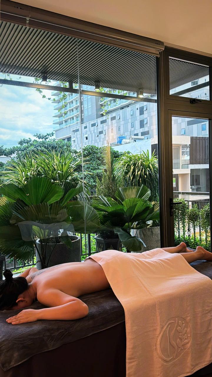 a woman is laying on a bed in a room with a view of a balcony