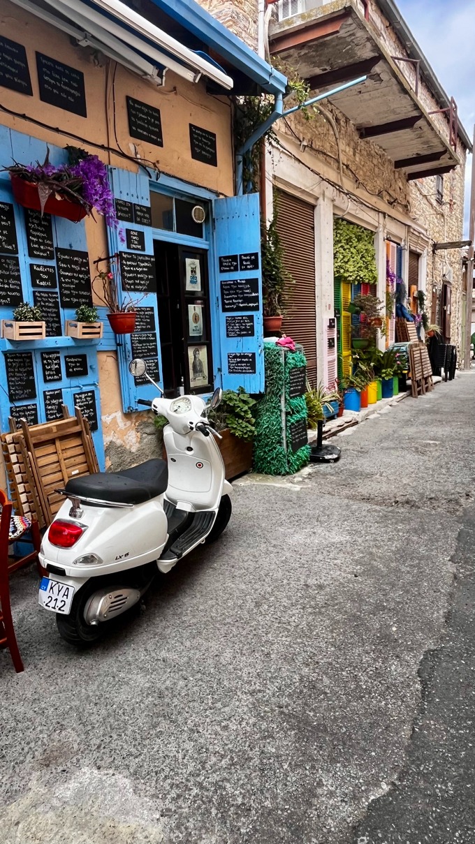 a scooter parked in front of a restaurant