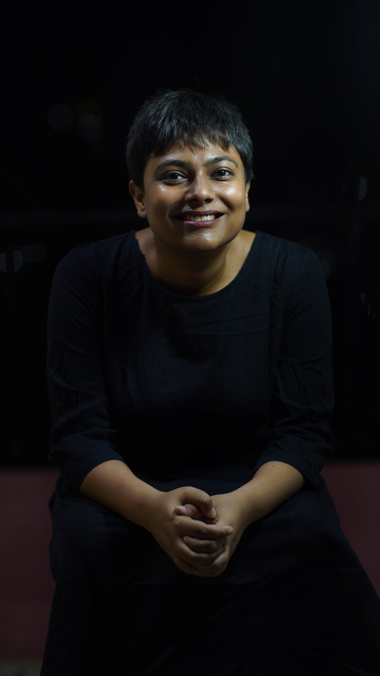 This is an image of the therapist. With a black background and clothing, a wide welcoming smile