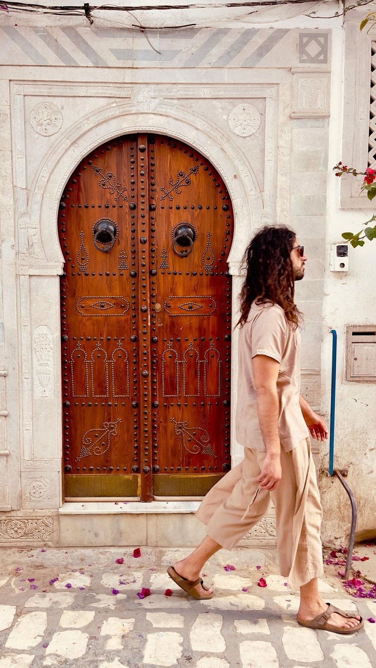 a man walking down a sidewalk 