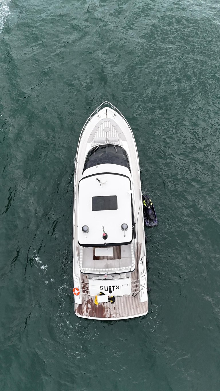 a boat with a man standing on the water