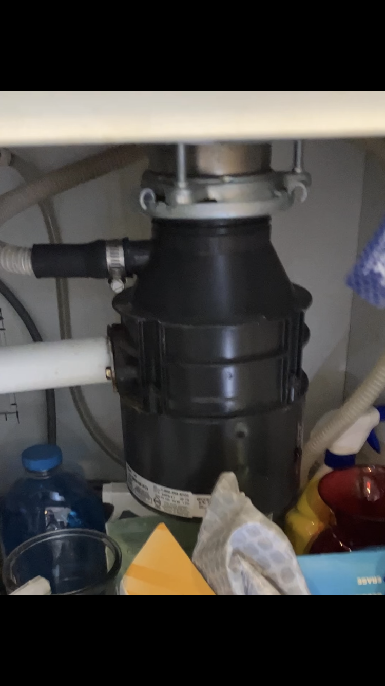 a garbage disposal under a sink in a kitchen
