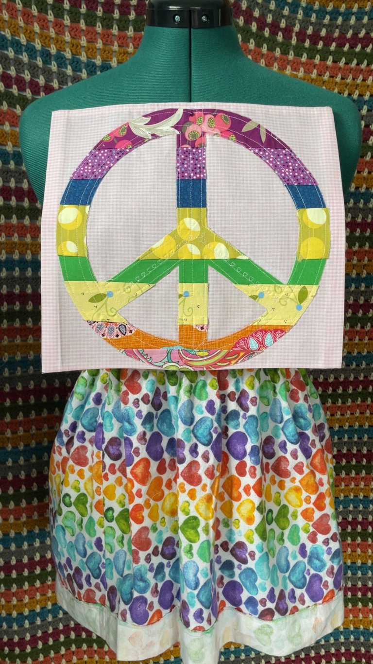 square Peace Flag rainbow peace sign sewn onto white and pink fabric