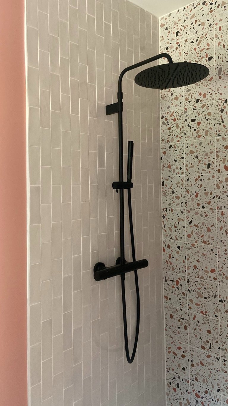 a shower with a shower head and a shower head