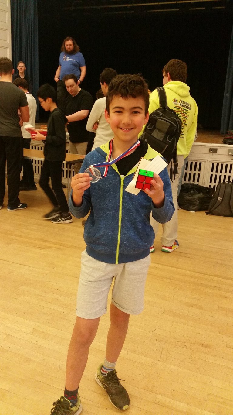 James Alonso holding up his first medal at a competition