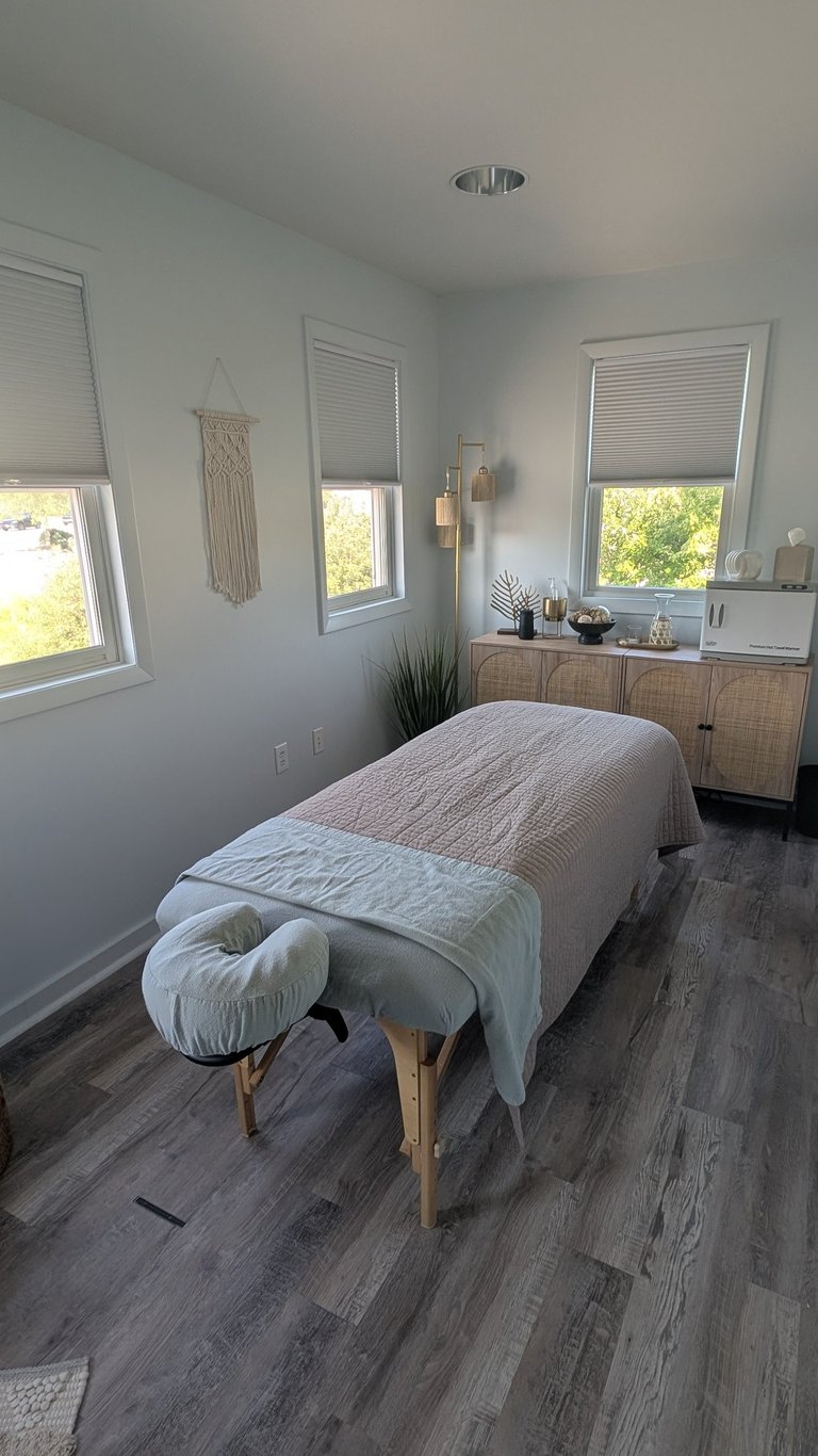a massage studio room with a massage table