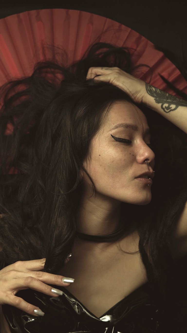 a woman with a red umbrella in a black dress