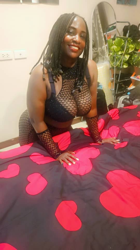 Black lady wearing sexy black bra and fishnet outfit
