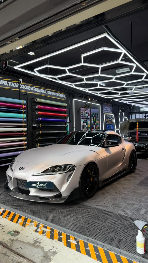Toyota Supra wrapped in satin pearl white vinyl at One 7 Garage