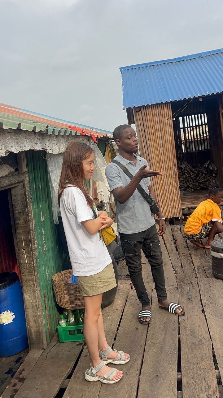 Dahomey African Tours Guide leading Tourists in Ganvie Stilt Village in Benin