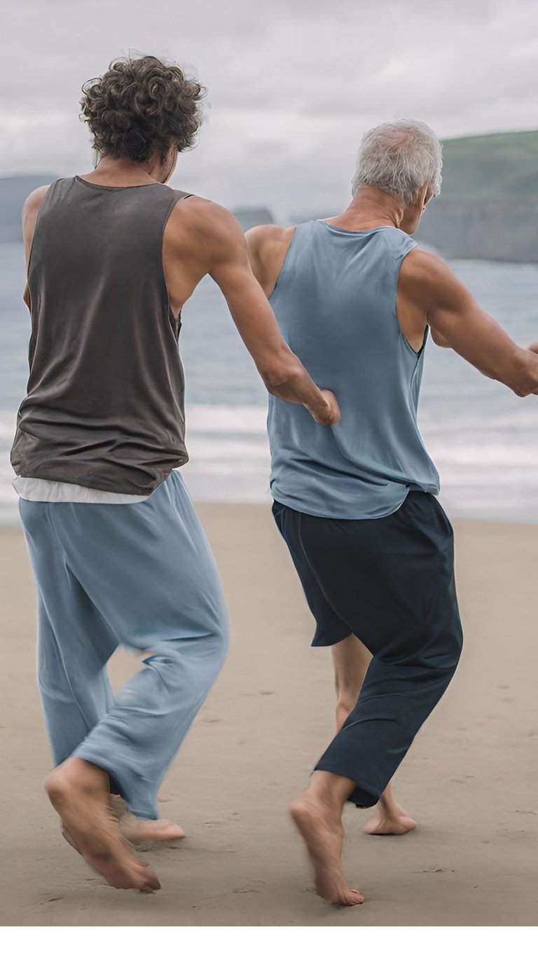 Two men dancing on the beach together