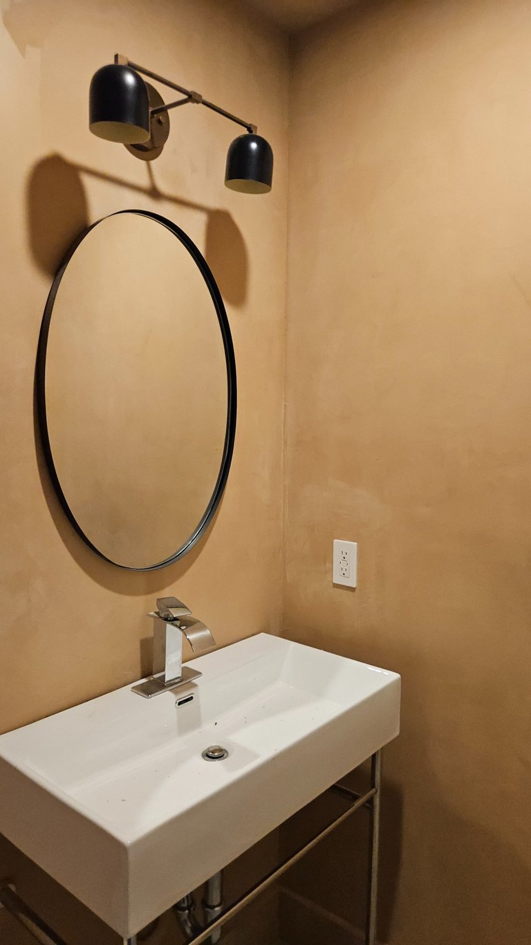 Bathroom vanity lighting installation in a remodeled residential home