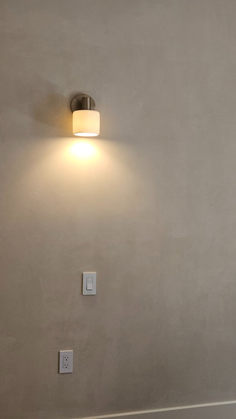 Modern wall sconce installed as part of a residential lighting project