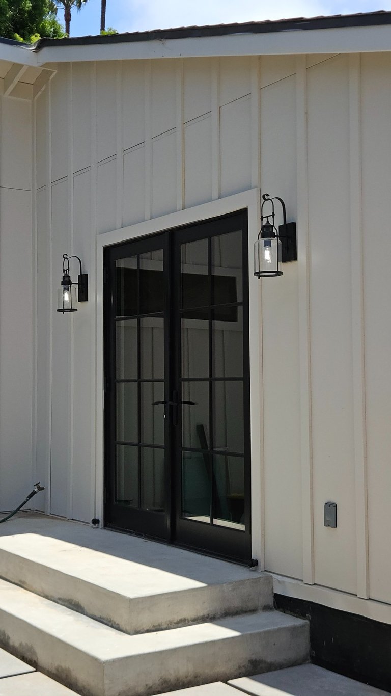 Exterior lighting installation at the entrance of a remodeled residential home