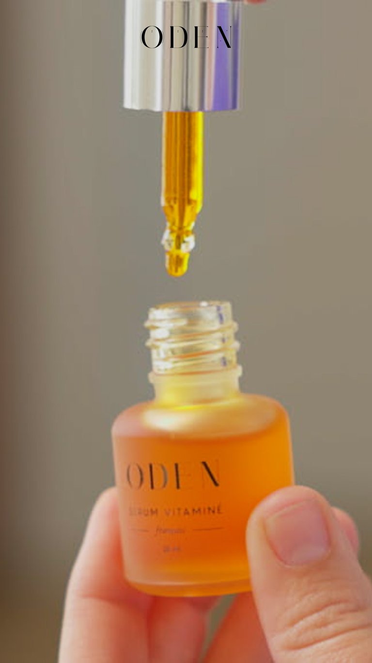 a person holding a bottle of liquid cosmetic  in their hand