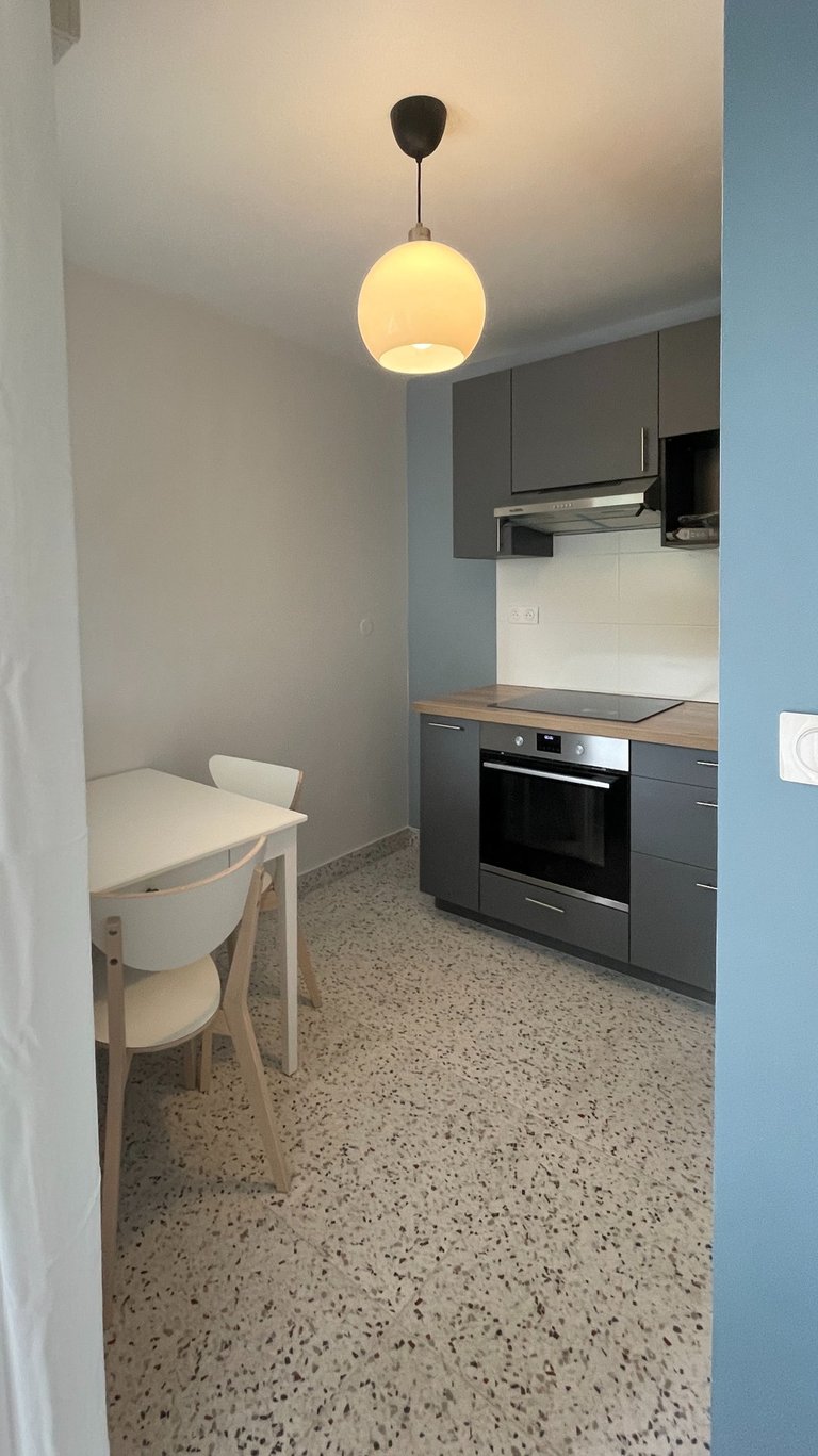 a kitchen with a table and chairs 