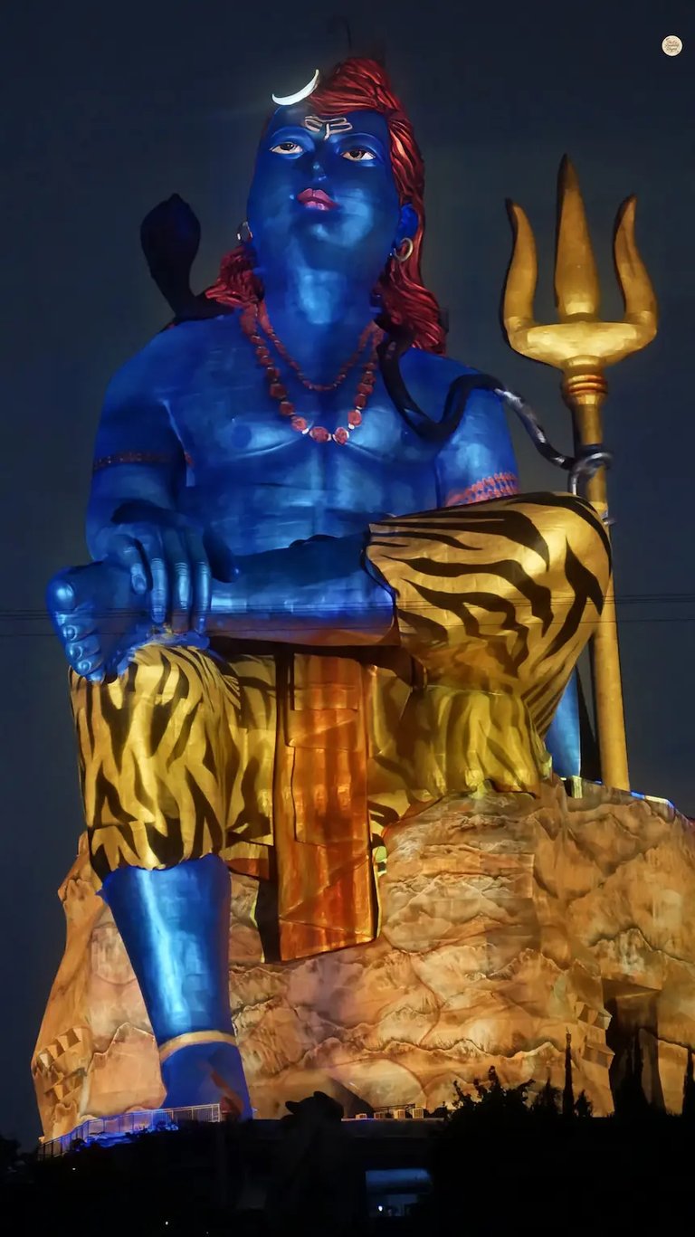 Light and sound show at Statue of Belief, illuminating the towering Shiva statue against the night sky.