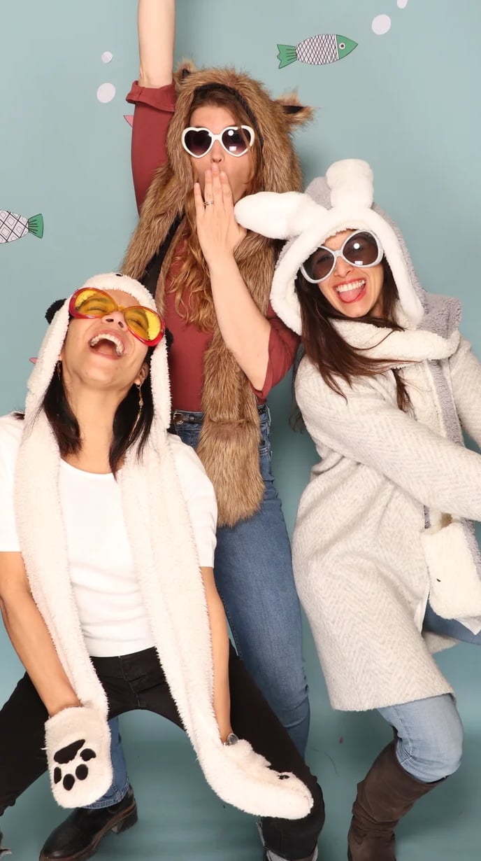 three women in animal print clothing posing for a photo